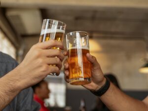 Clinking non alcoholic beer glasses in celebration of its benefits 